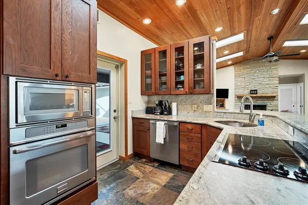 a kitchen with stainless steel appliances granite countertop a stove and a sink