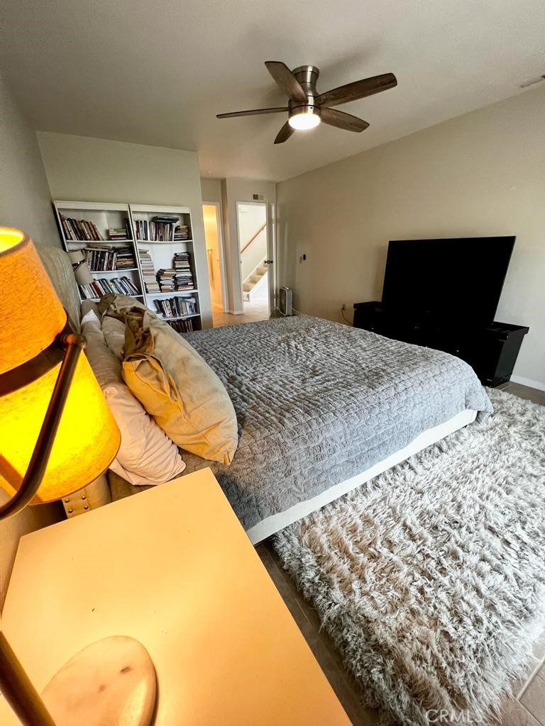 803 Caminito Azul Carlsbad, CA 92011 - Photo 14 of 44 a bedroom with a bed and ceiling fan