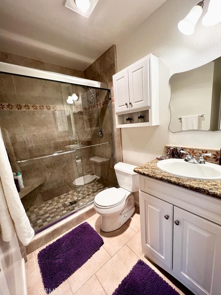 803 Caminito Azul Carlsbad, CA 92011 - Photo 20 of 44 a bathroom with a granite countertop sink toilet and shower
