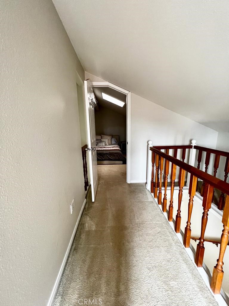 803 Caminito Azul Carlsbad, CA 92011 - Photo 30 of 44 a view of a hallway with wooden floor and staircase