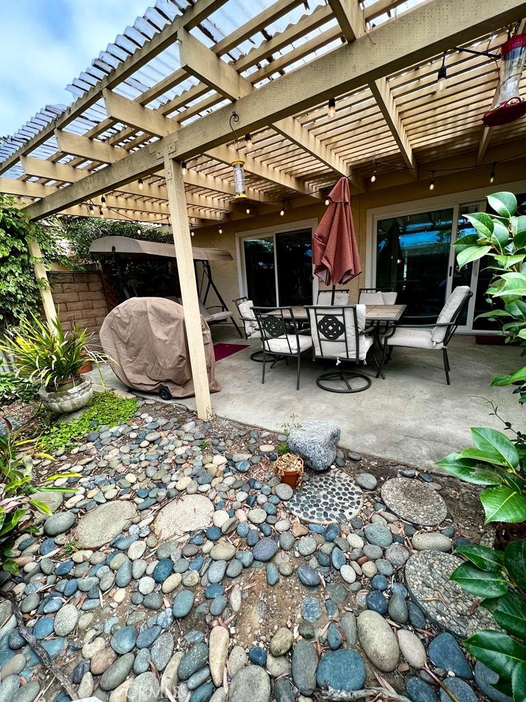 803 Caminito Azul Carlsbad, CA 92011 - Photo 40 of 44 a view of a chairs and table in backyard of the house