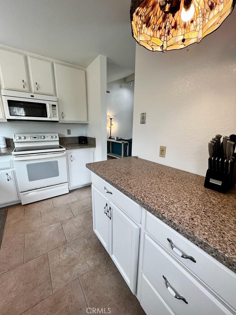 803 Caminito Azul Carlsbad, CA 92011 - Photo 8 of 44 a kitchen with stainless steel appliances granite countertop a sink a stove and cabinets