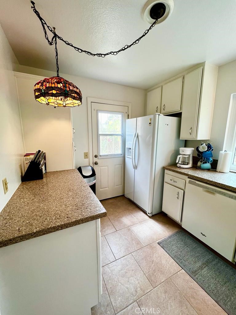 803 Caminito Azul Carlsbad, CA 92011 - Photo 10 of 44 a kitchen with stainless steel appliances granite countertop a sink stove and refrigerator