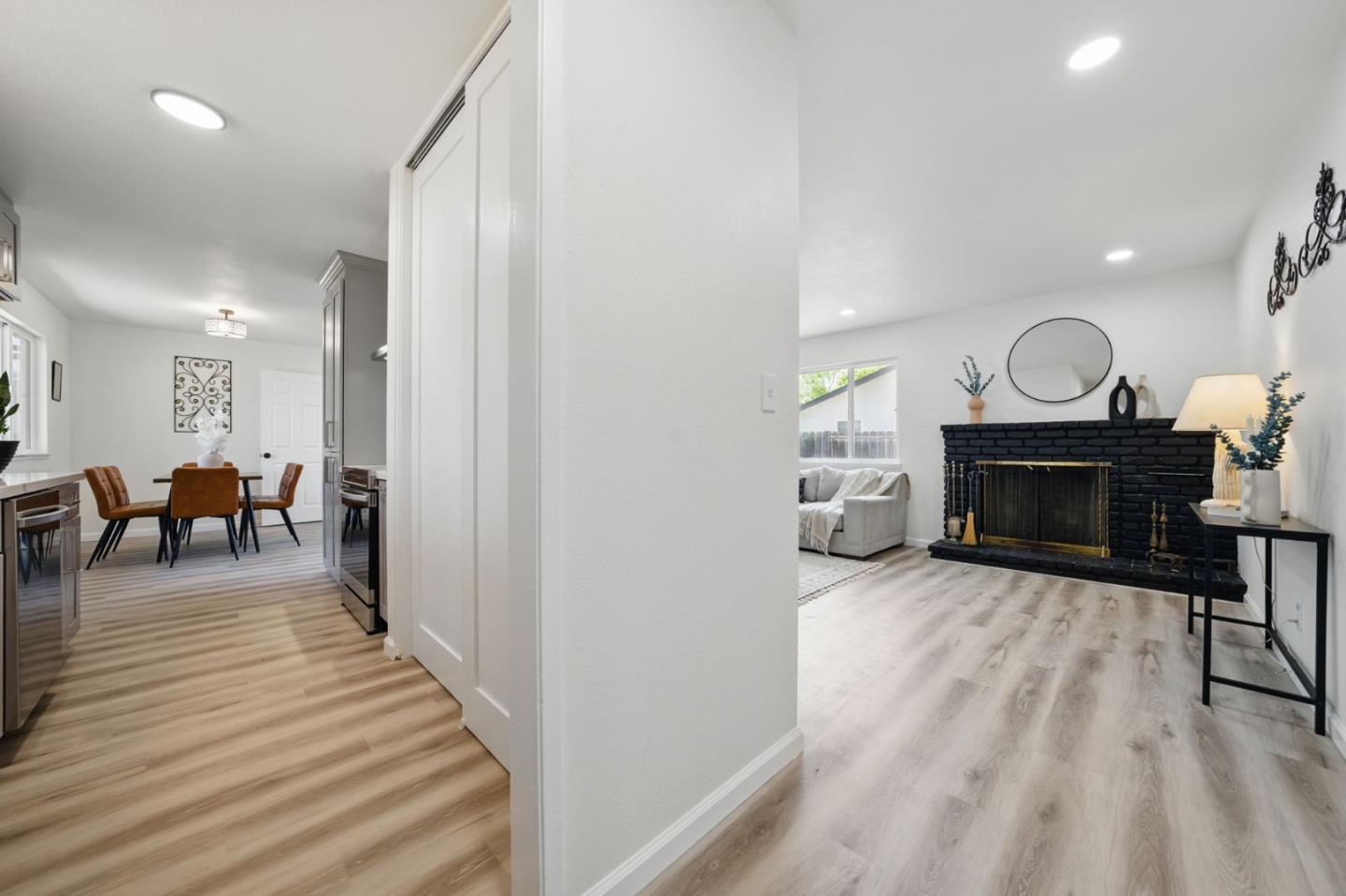 1693 Greentree Drive Concord, CA 94521 - Photo 15 of 40 a living room with furniture a fireplace and a chandelier