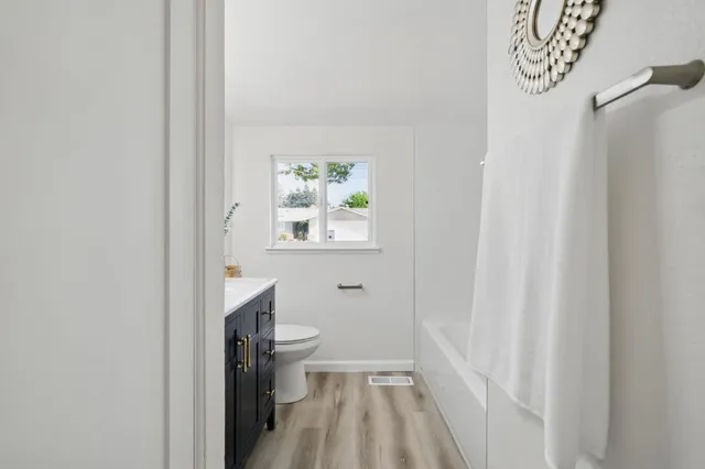 a bathroom with a bathtub and window