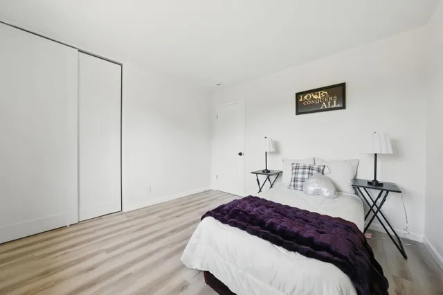 a spacious bedroom with a bed and a table