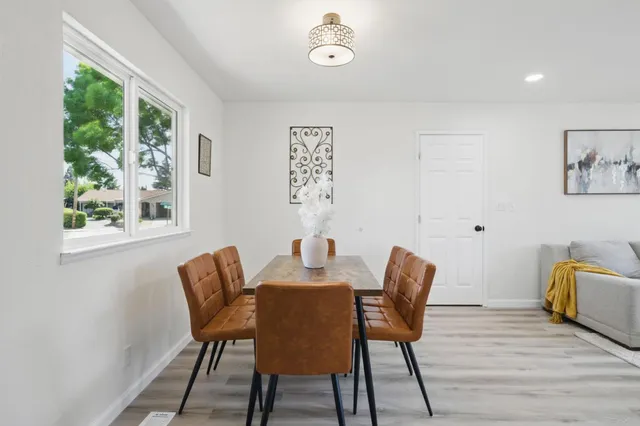 a view of a dining room with furniture window and wooden floor