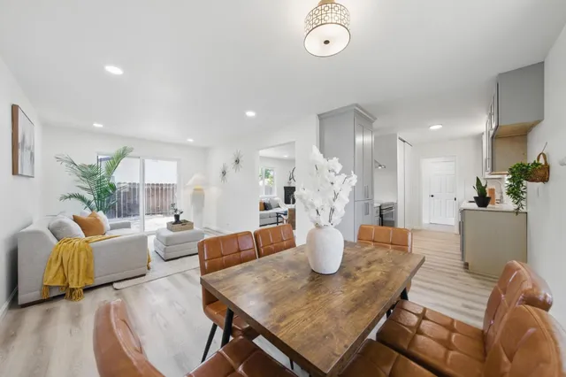 a living room with furniture a fireplace and a potted plant