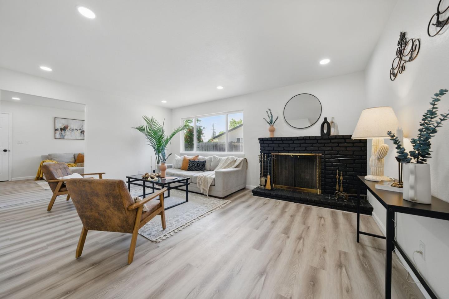 1693 Greentree Drive Concord, CA 94521 - Photo 9 of 40 a living room with furniture a fireplace and a potted plant
