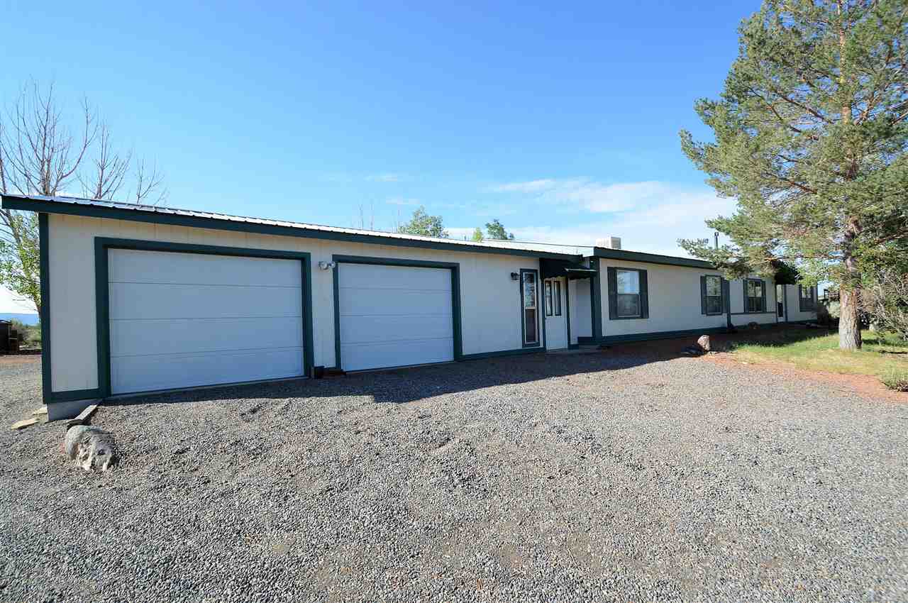 9198 1995th Road Austin, CO 81410 - Photo 1 of 15 a front view of house with garage