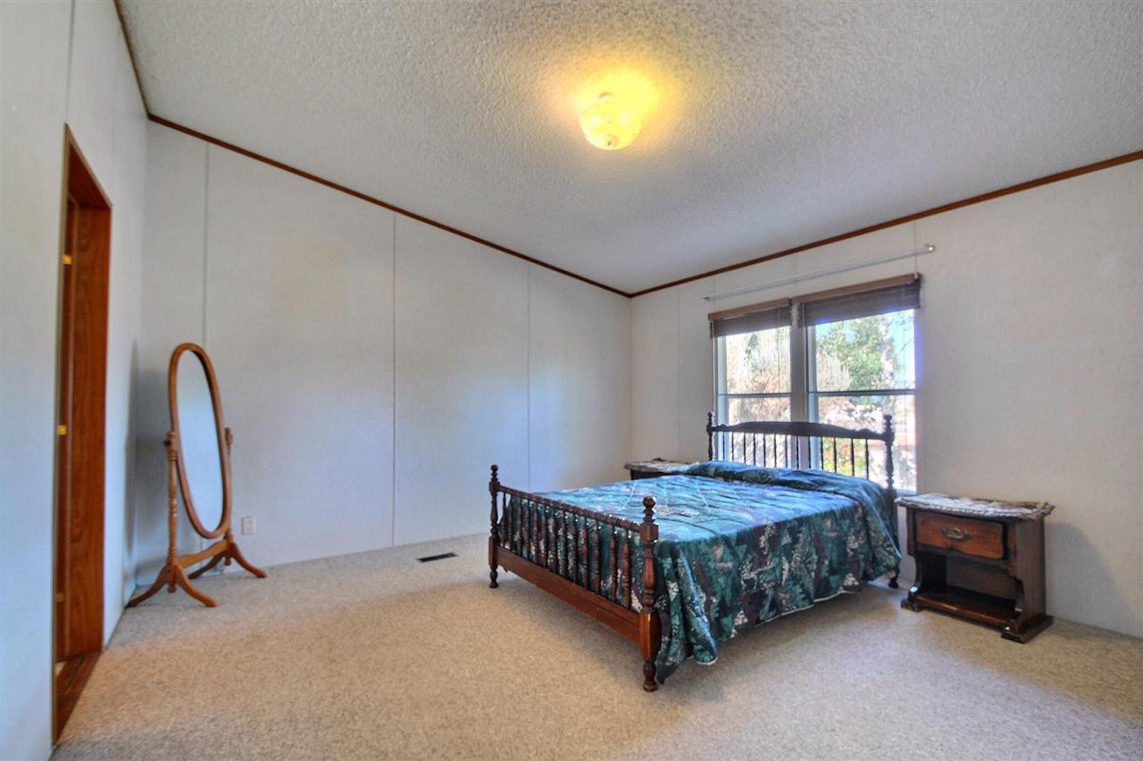 9198 1995th Road Austin, CO 81410 - Photo 12 of 15 a bedroom with a bed chair and a window