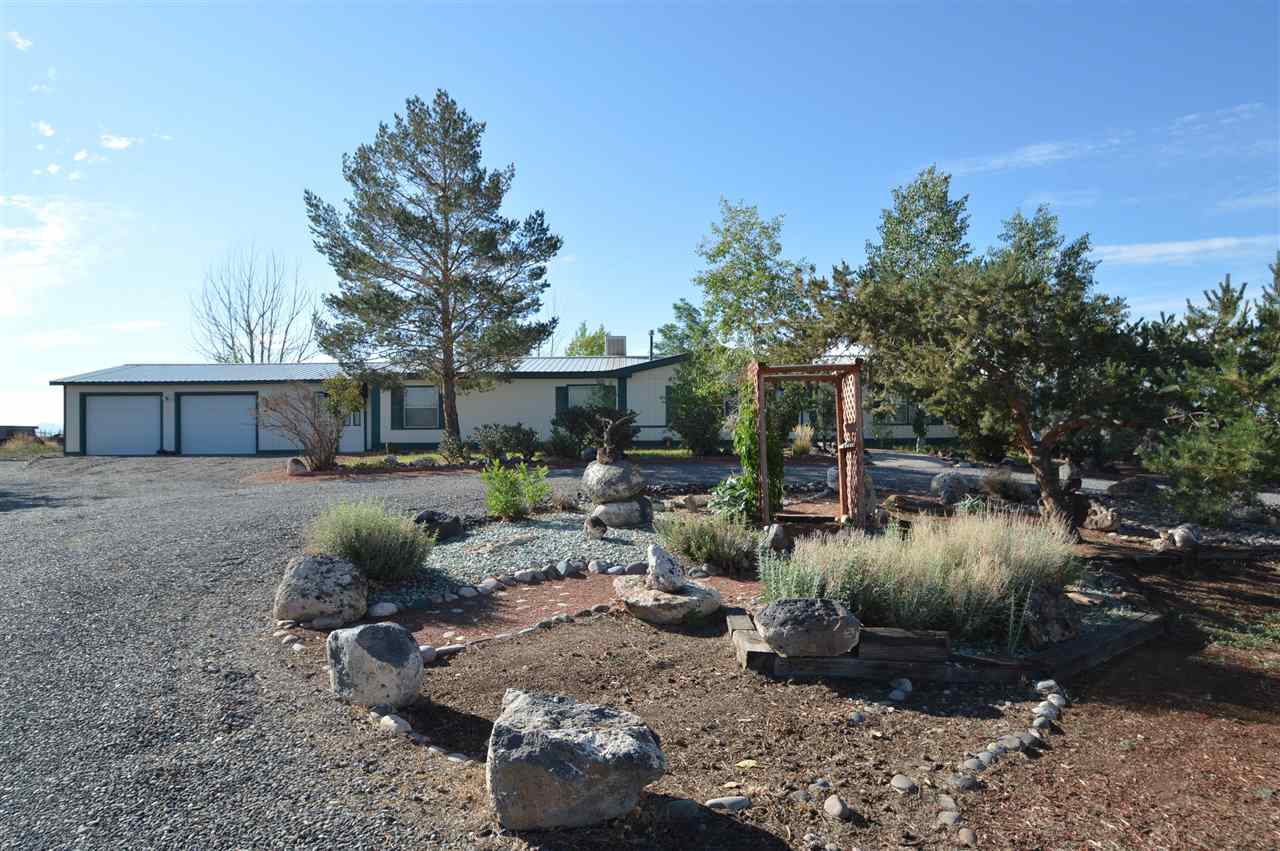 9198 1995th Road Austin, CO 81410 - Photo 13 of 15 a view of a backyard with table and chairs potted plants and large tree