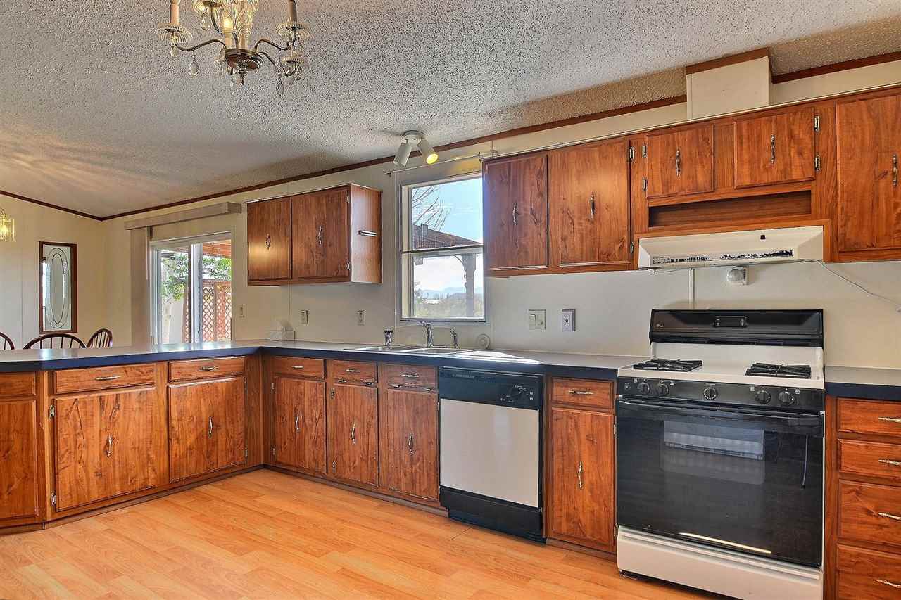 9198 1995th Road Austin, CO 81410 - Photo 3 of 15 a kitchen with stainless steel appliances wooden cabinets and a stove top oven