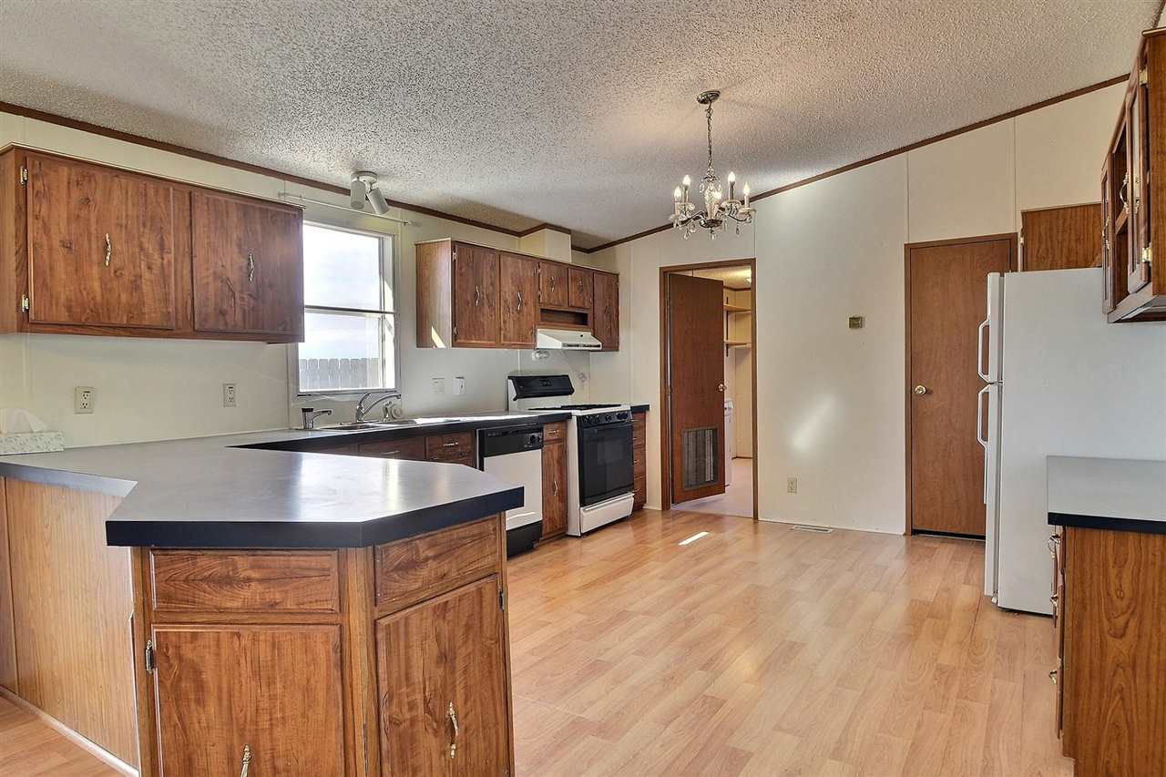 9198 1995th Road Austin, CO 81410 - Photo 4 of 15 a kitchen with stainless steel appliances granite countertop a sink stove and refrigerator