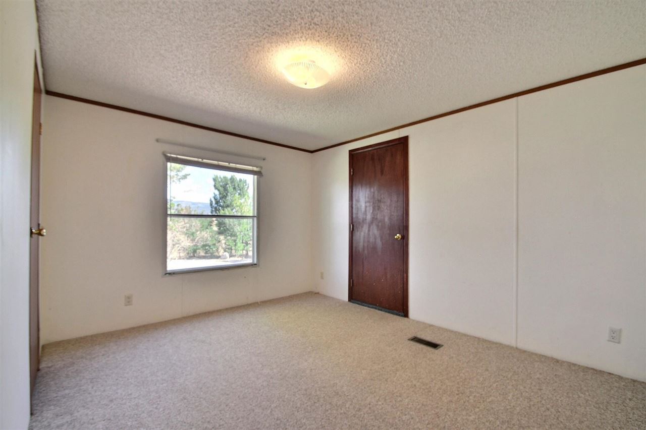 9198 1995th Road Austin, CO 81410 - Photo 5 of 15 an empty room with windows and closet