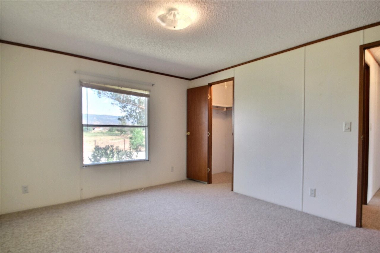 9198 1995th Road Austin, CO 81410 - Photo 7 of 15 an empty room with windows