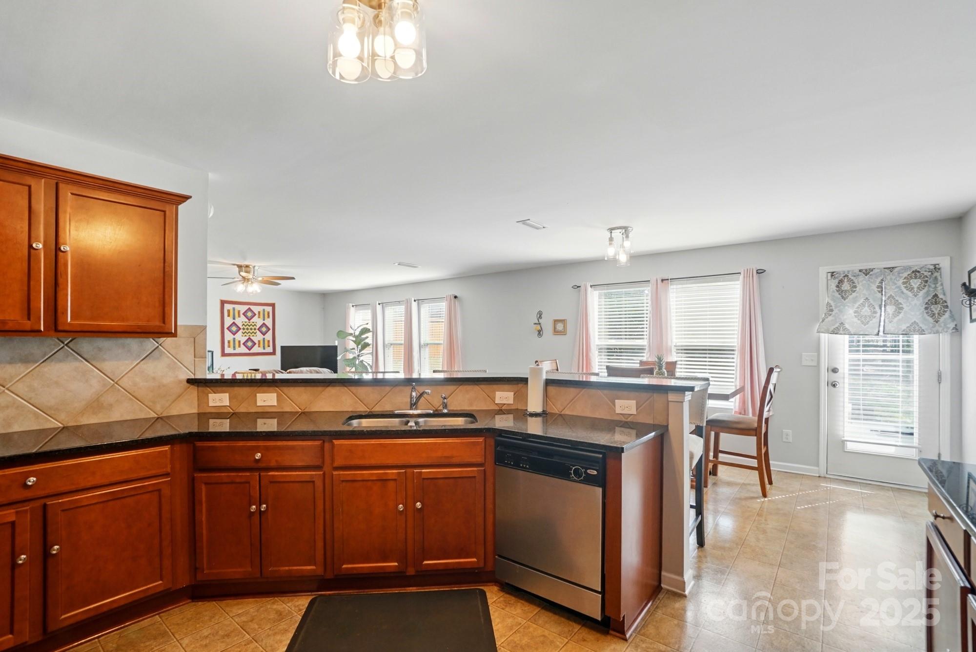 3272 Saddlebrook Drive Midland, NC 28107 - Photo 18 of 44 a kitchen with granite countertop a stove and cabinets