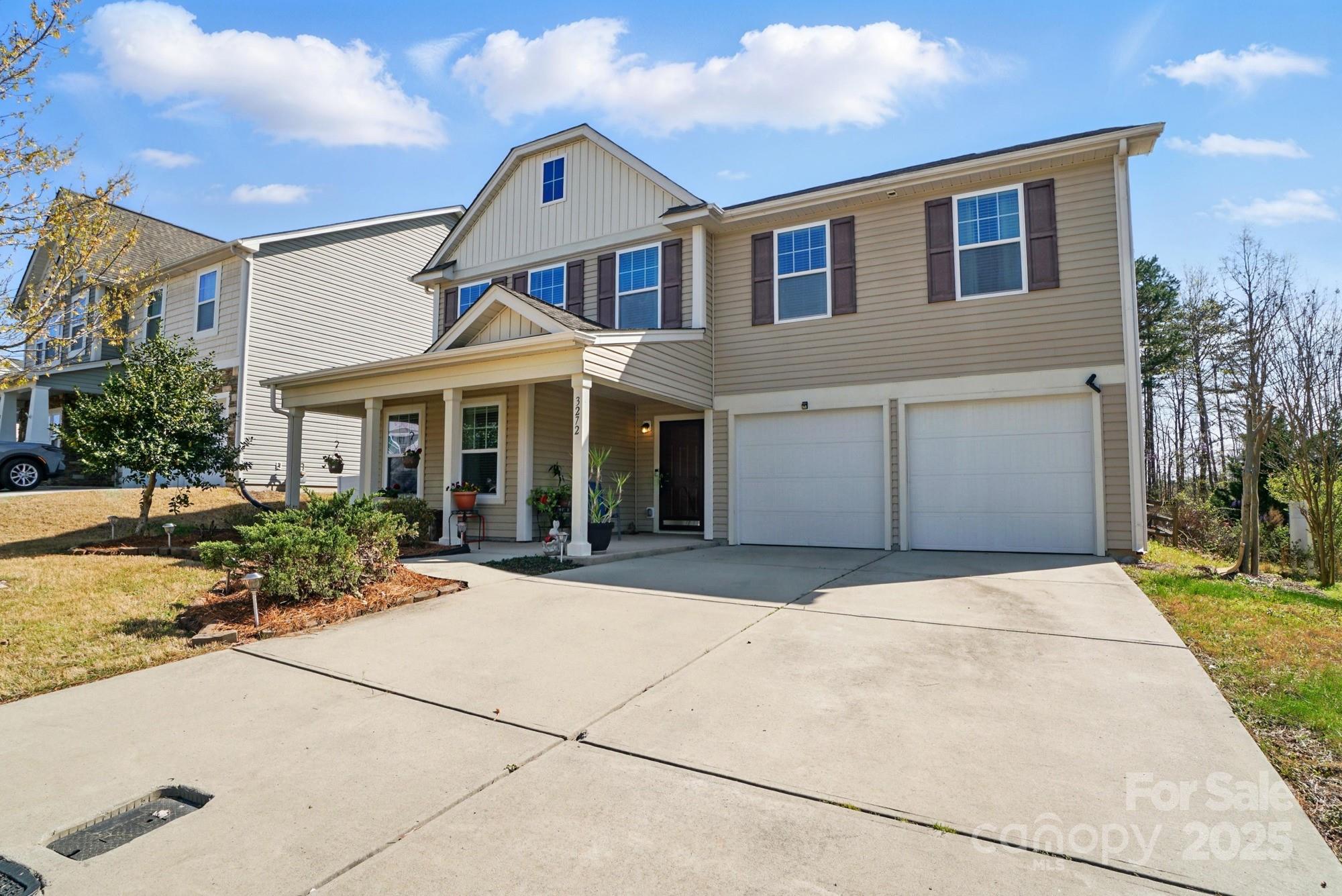 3272 Saddlebrook Drive Midland, NC 28107 - Photo 2 of 44 a front view of a house with a yard and potted plants