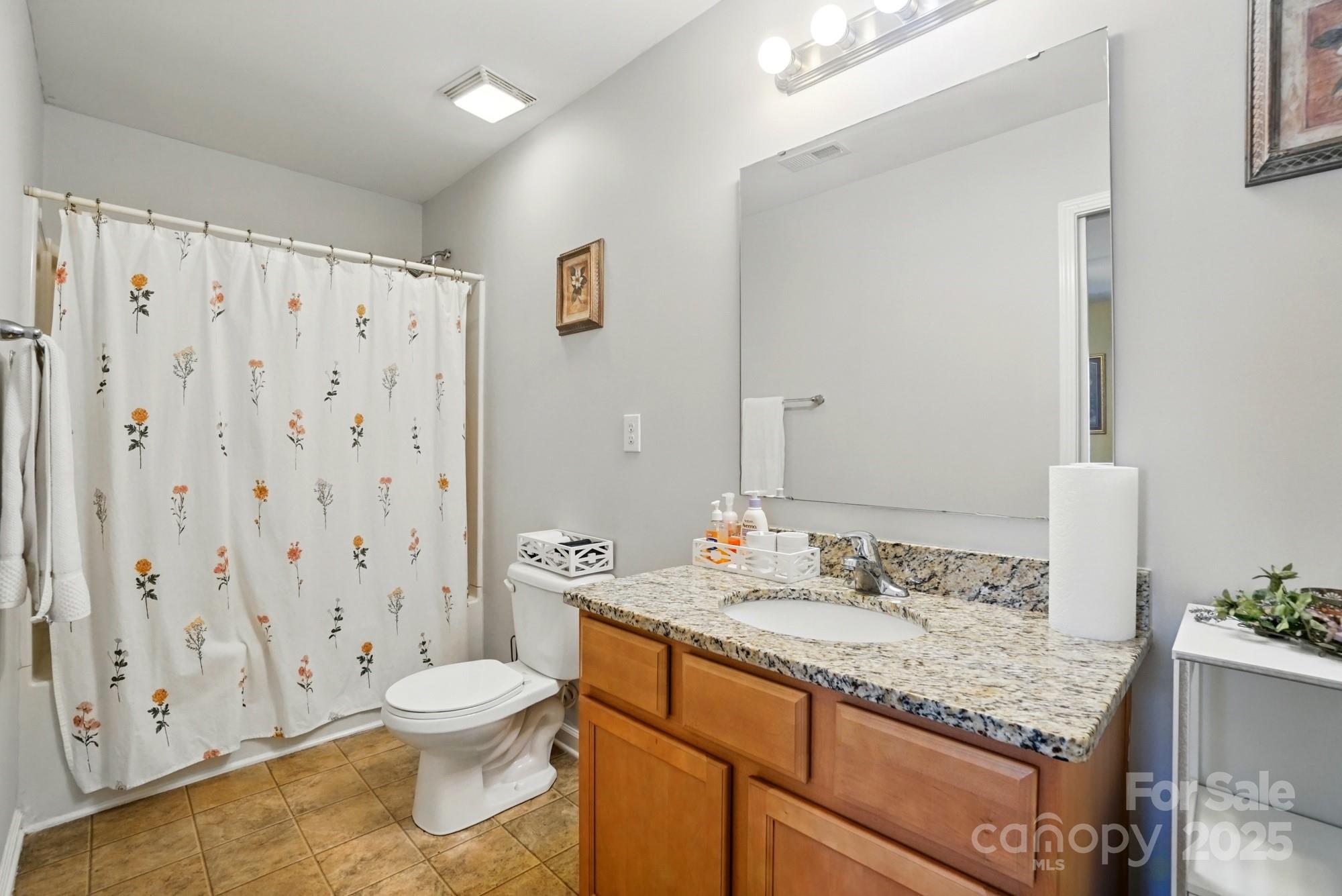 3272 Saddlebrook Drive Midland, NC 28107 - Photo 24 of 44 a bathroom with a granite countertop sink toilet and shower