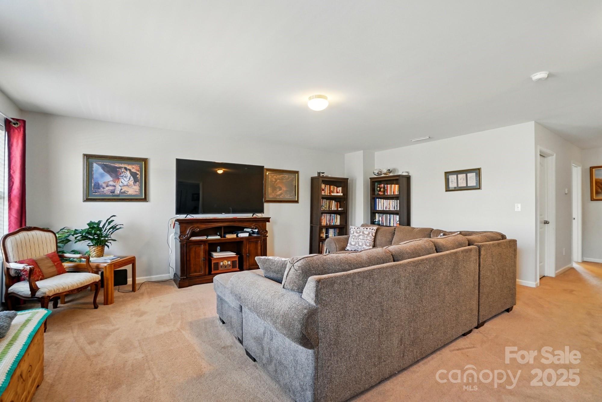3272 Saddlebrook Drive Midland, NC 28107 - Photo 26 of 44 a living room with furniture and a flat screen tv