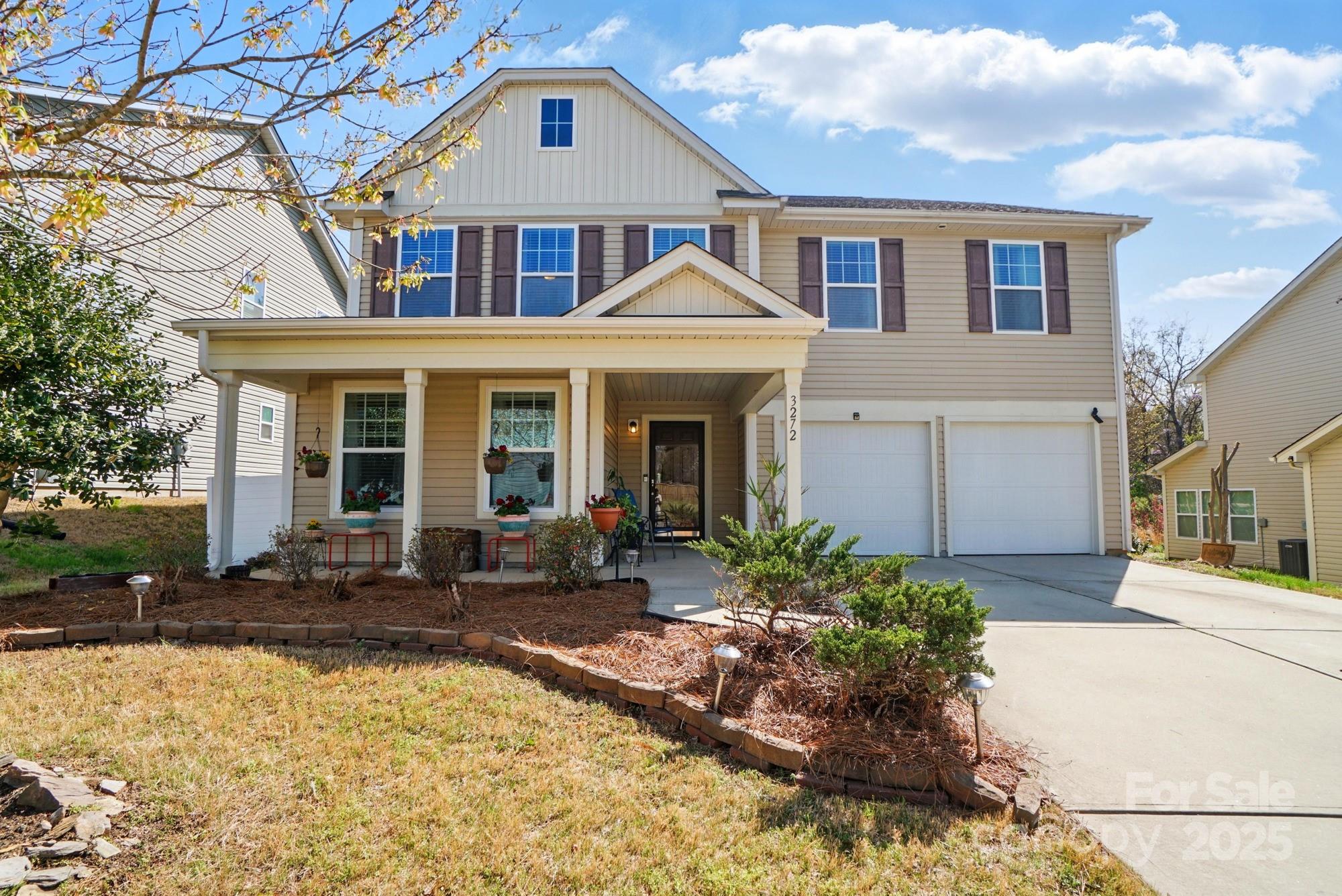 3272 Saddlebrook Drive Midland, NC 28107 - Photo 3 of 44 a front view of a house with garden