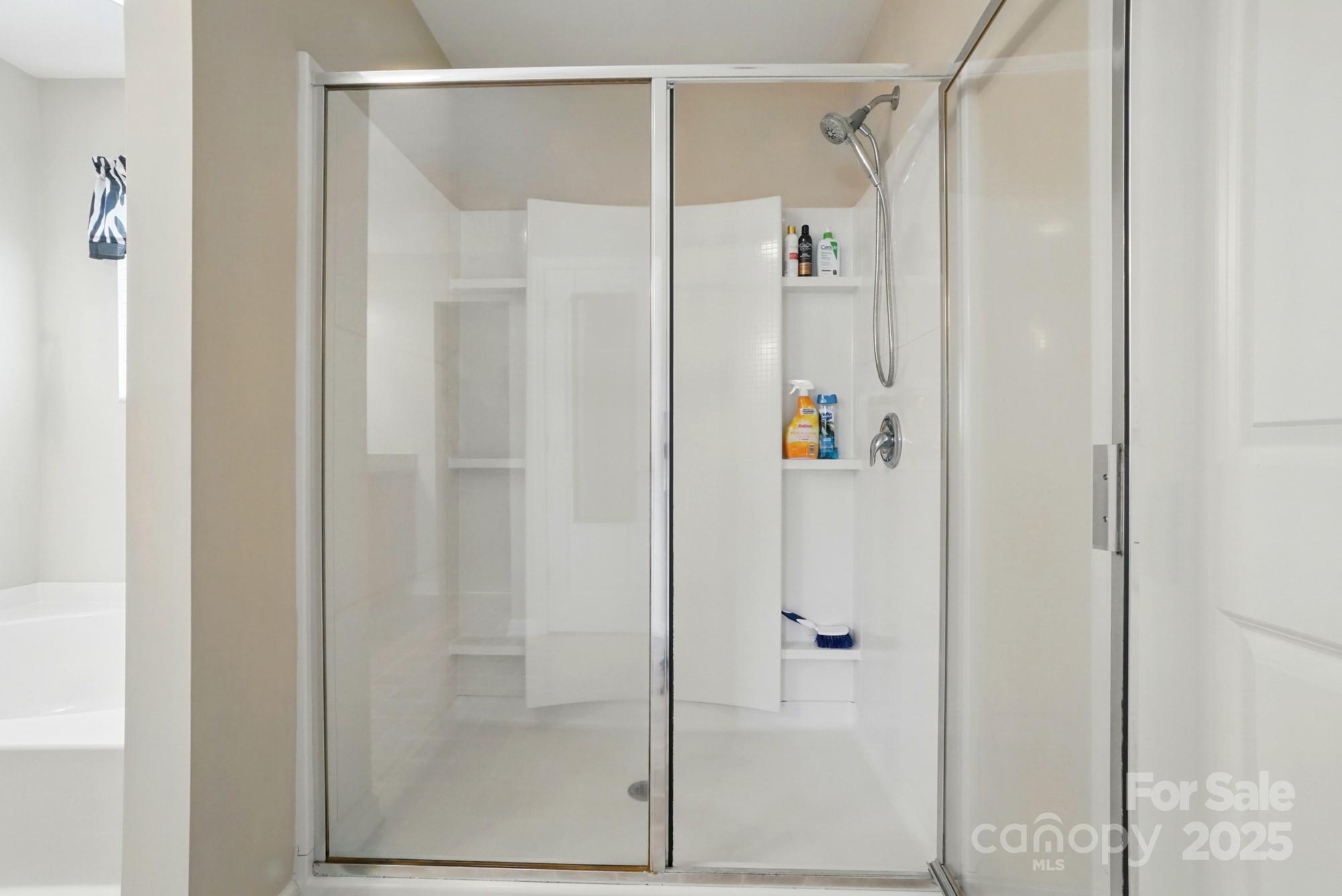 3272 Saddlebrook Drive Midland, NC 28107 - Photo 33 of 44 a bathroom with a shower and a glass door
