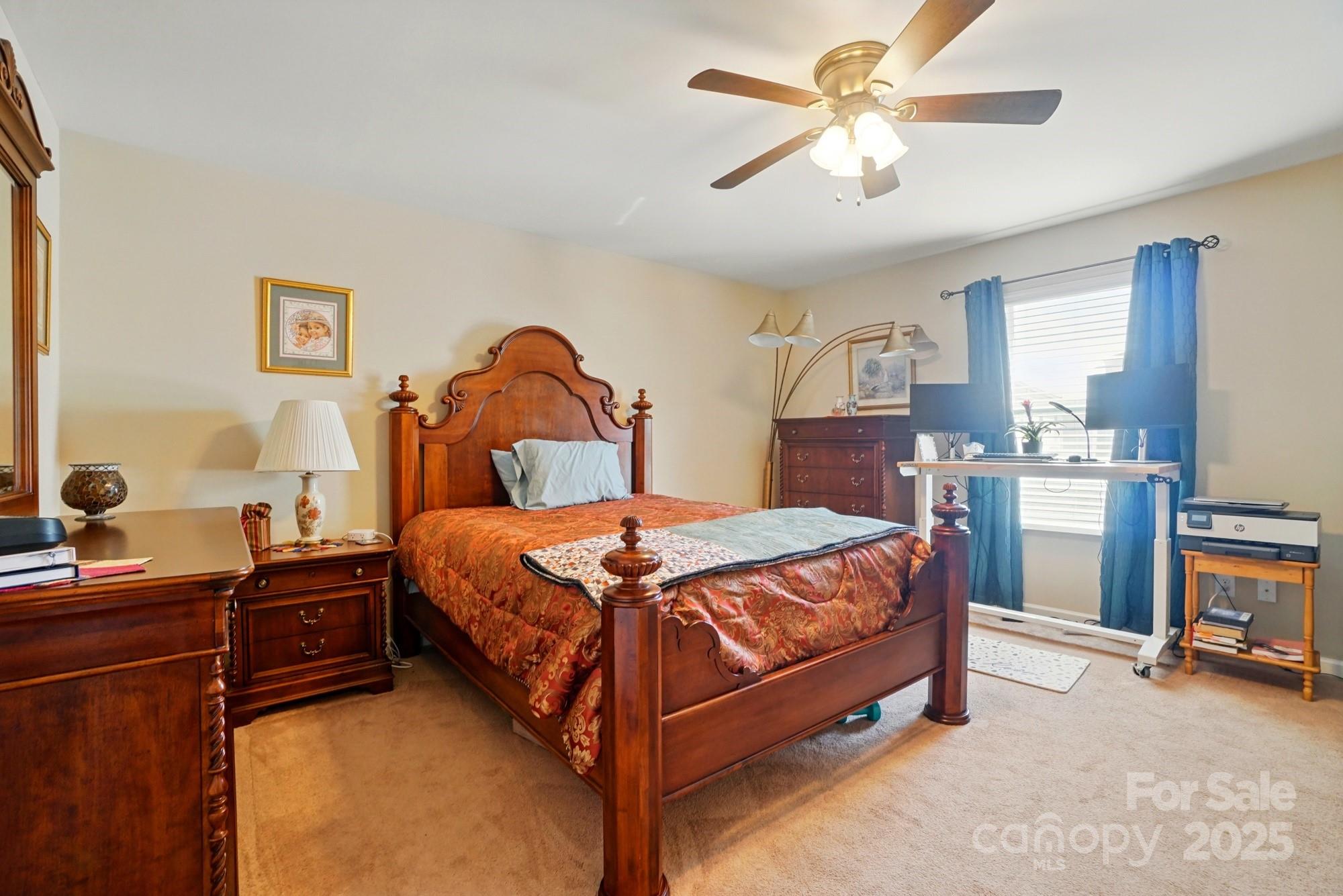 3272 Saddlebrook Drive Midland, NC 28107 - Photo 34 of 44 a bedroom with a bed and a chandelier