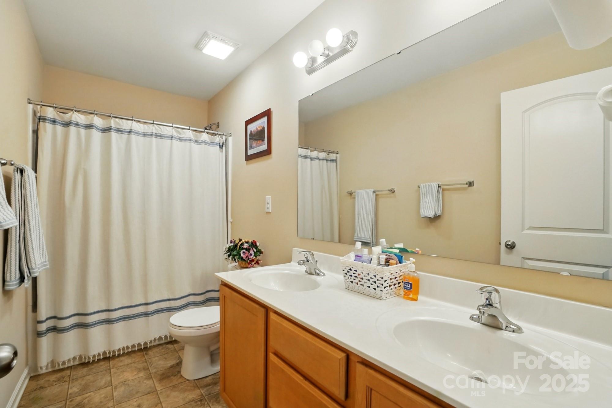 3272 Saddlebrook Drive Midland, NC 28107 - Photo 37 of 44 a bathroom with a sink toilet double vanity and shower