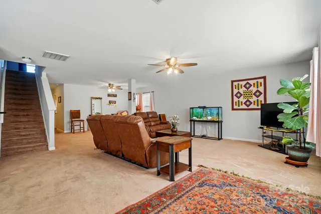 a living room with furniture and a potted plant