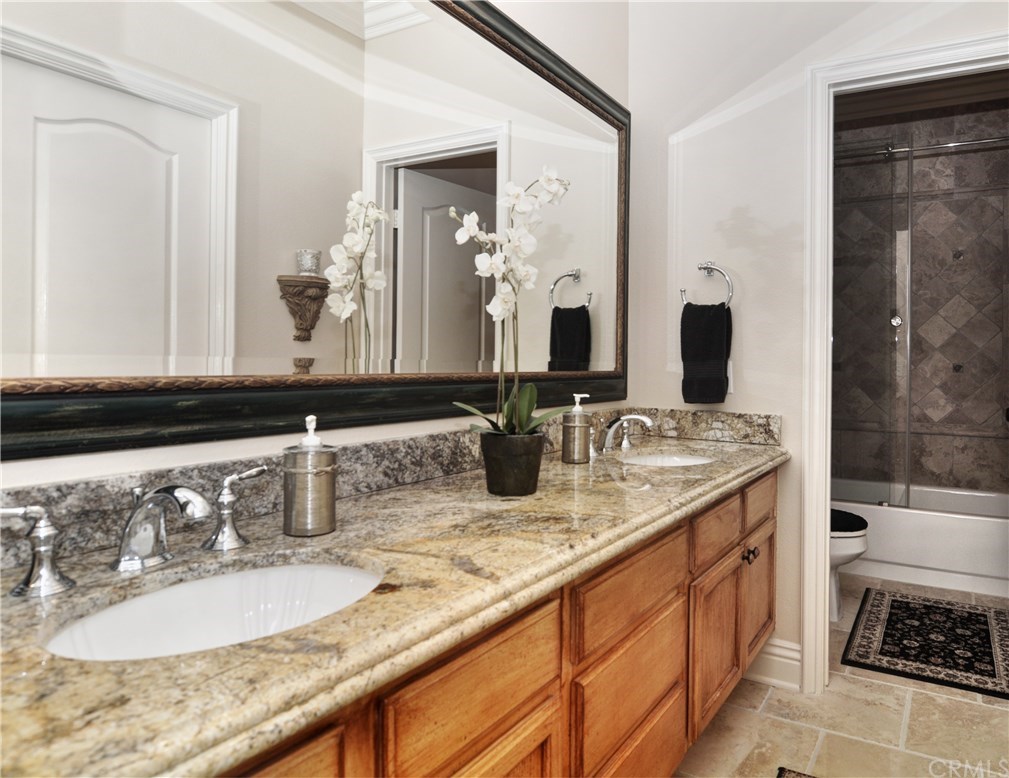 16 Via Adelia San Clemente, CA 92672 - Photo 36 of 42 a bathroom with a granite countertop sink double vanity and a mirror