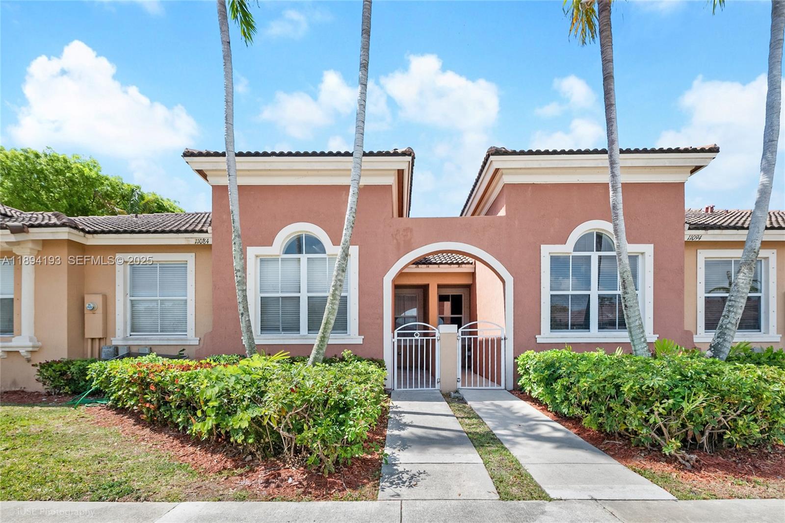 11084 Southwest 237th Lane Homestead, FL 33032 - Photo 1 of 12 a front view of a house with garden