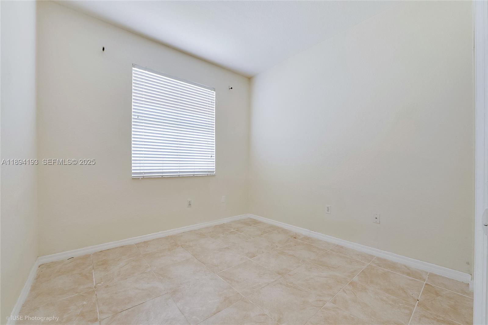 11084 Southwest 237th Lane Homestead, FL 33032 - Photo 4 of 12 an empty room with a window