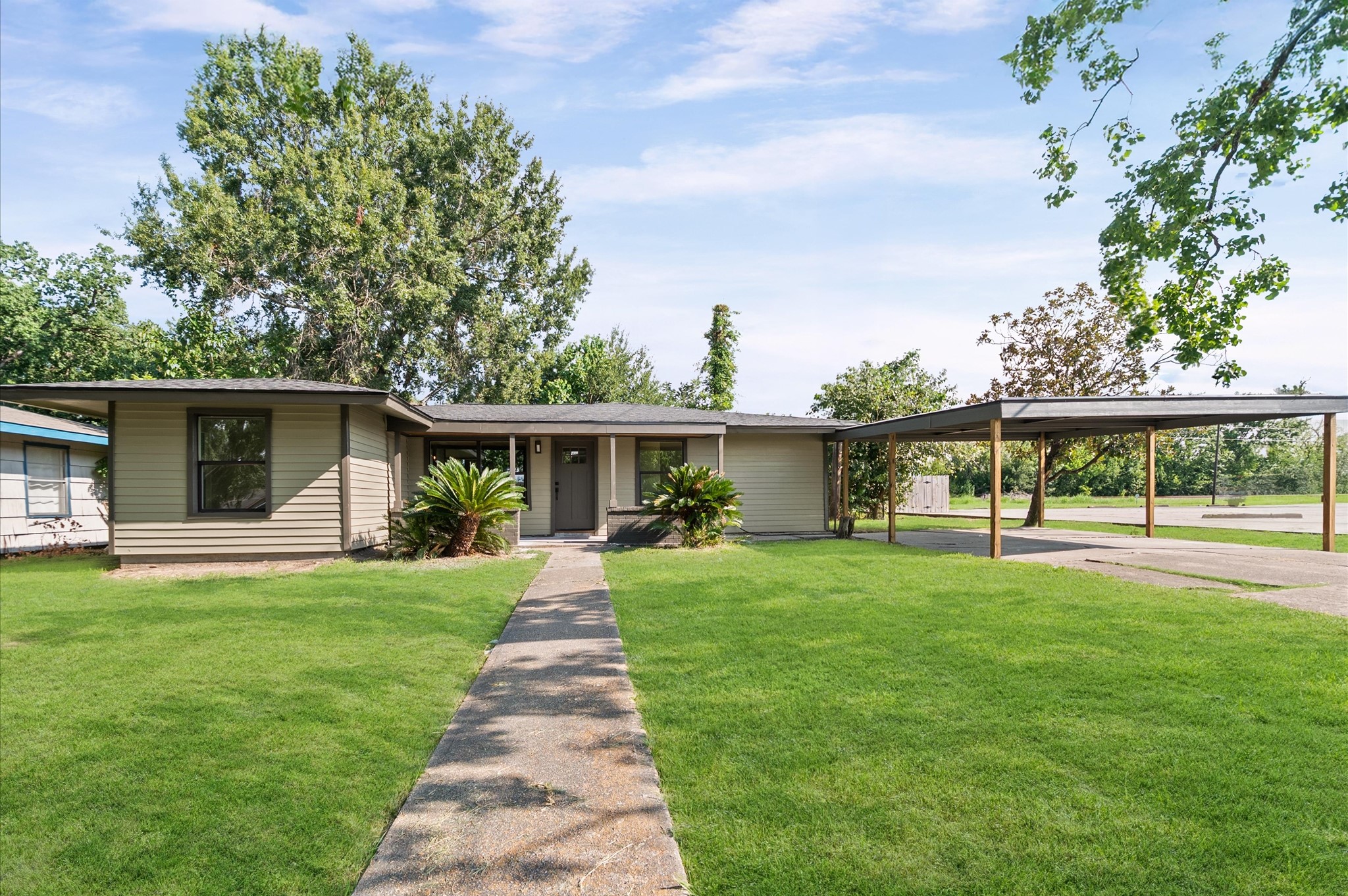6527 Beekman Road Houston, TX 77021 - Photo 2 of 22 a front view of a house with a yard and potted plants