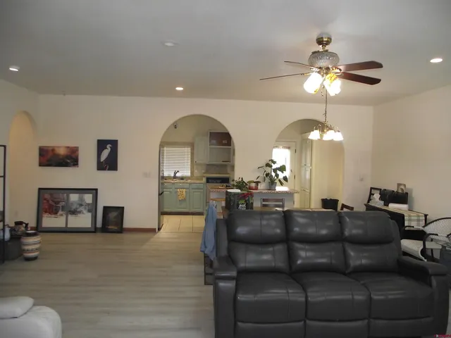 a living room with furniture a chandelier and a chandelier
