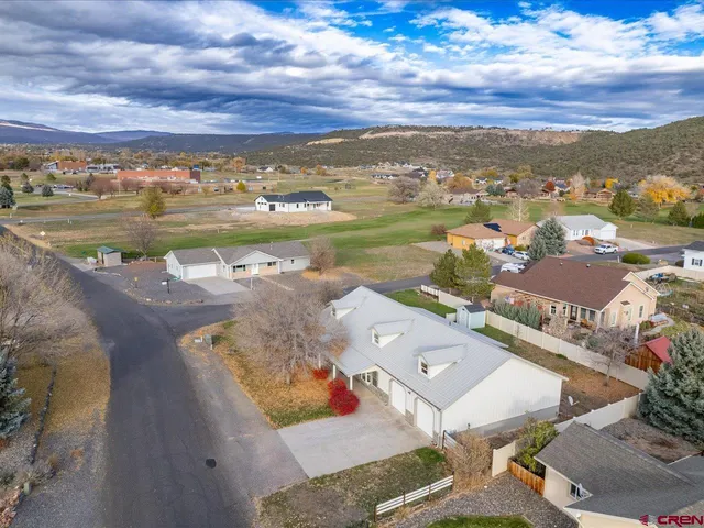 an aerial view of a residential houses with outdoor space