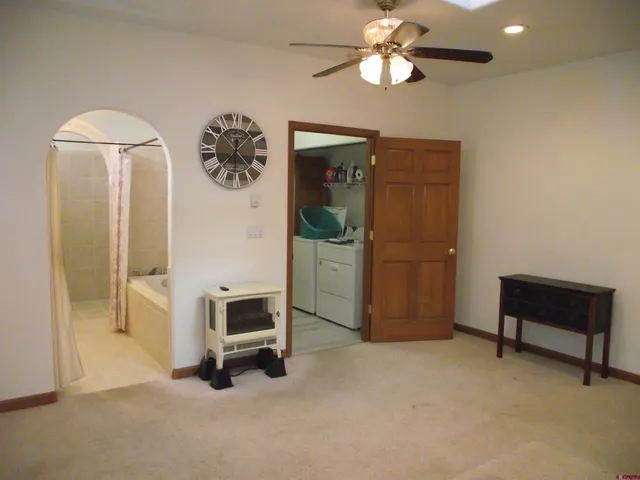 a bathroom with a sink and mirror with bathtub