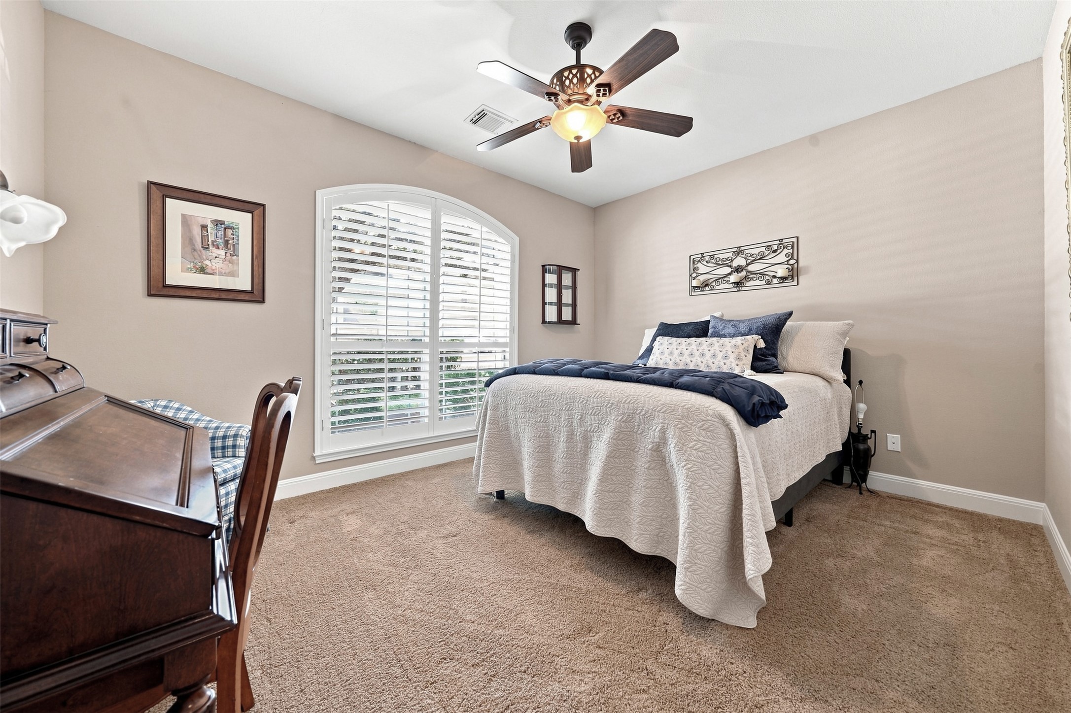 402 Ridgetop Bend Cedar Park, TX 78613 - Photo 27 of 40 An arched window with built-in shutters brings architectural character to this carpeted bedroom.
