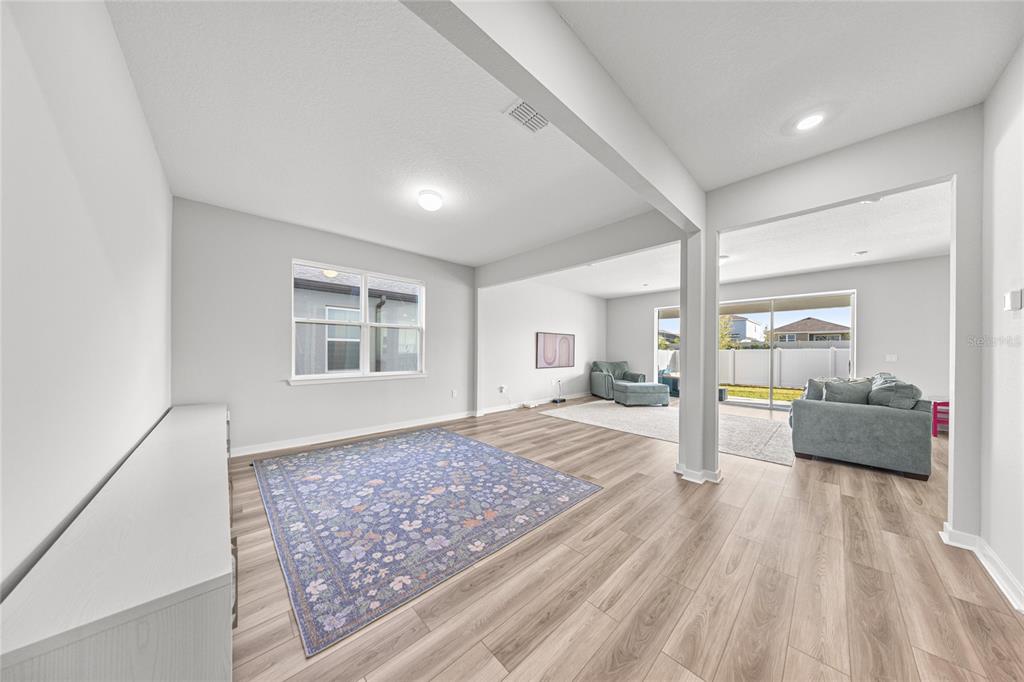 4472 Southwest 84th St Road Ocala, FL 34476 - Photo 14 of 50 a large bedroom with a bed and wooden floor