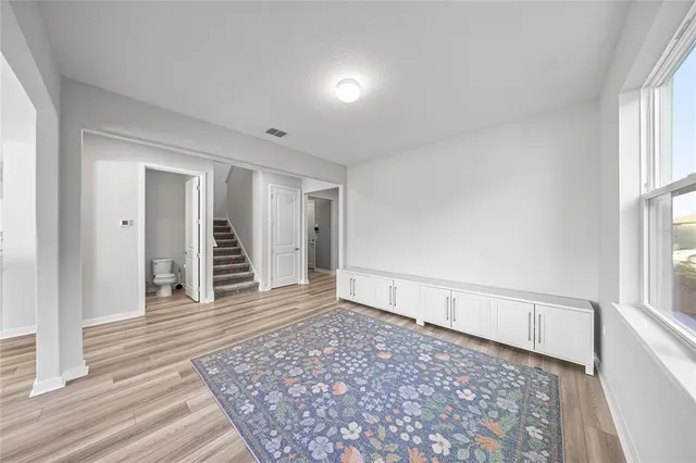 wooden floor in an empty room with a window