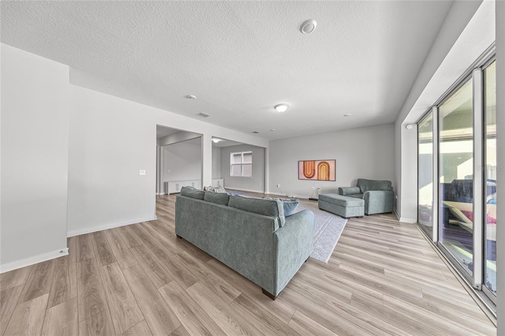 4472 Southwest 84th St Road Ocala, FL 34476 - Photo 18 of 50 a living room with furniture and a wooden floor
