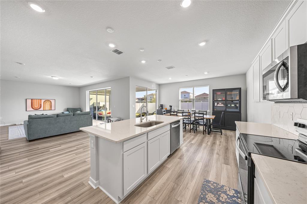 4472 Southwest 84th St Road Ocala, FL 34476 - Photo 23 of 50 a large white kitchen with a large window and stainless steel appliances