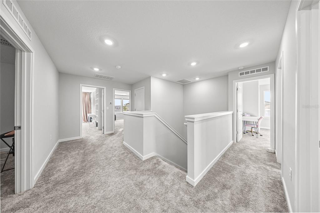 4472 Southwest 84th St Road Ocala, FL 34476 - Photo 25 of 50 a view of a hallway with kitchen and white walls