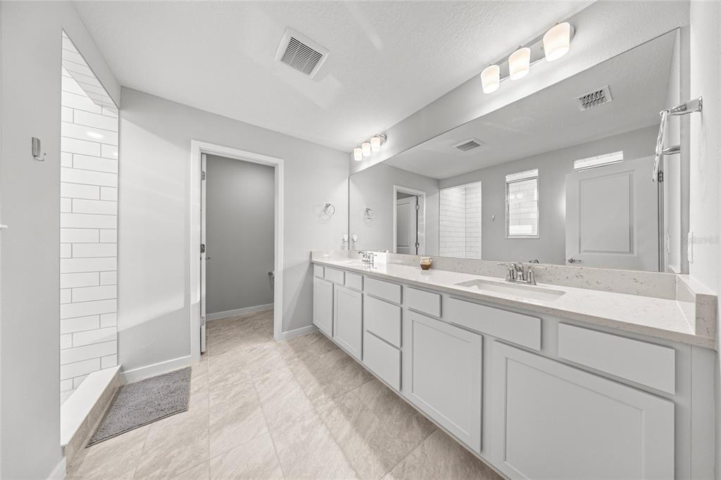 4472 Southwest 84th St Road Ocala, FL 34476 - Photo 28 of 50 a large bathroom with a double vanity sink mirror and