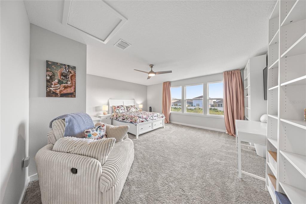 4472 Southwest 84th St Road Ocala, FL 34476 - Photo 31 of 50 a living room with furniture and a floor to ceiling window