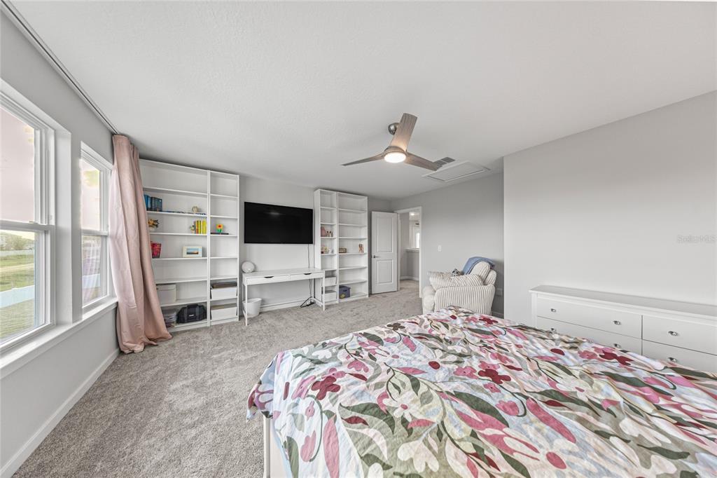 4472 Southwest 84th St Road Ocala, FL 34476 - Photo 32 of 50 a bedroom with a bed and a flat screen tv