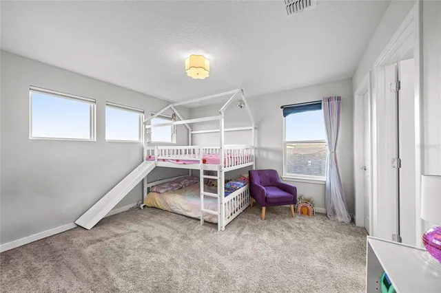 a view of play room with toys and air hockey table