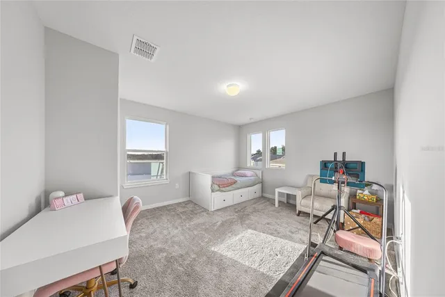 a spacious bedroom with a bed and furniture