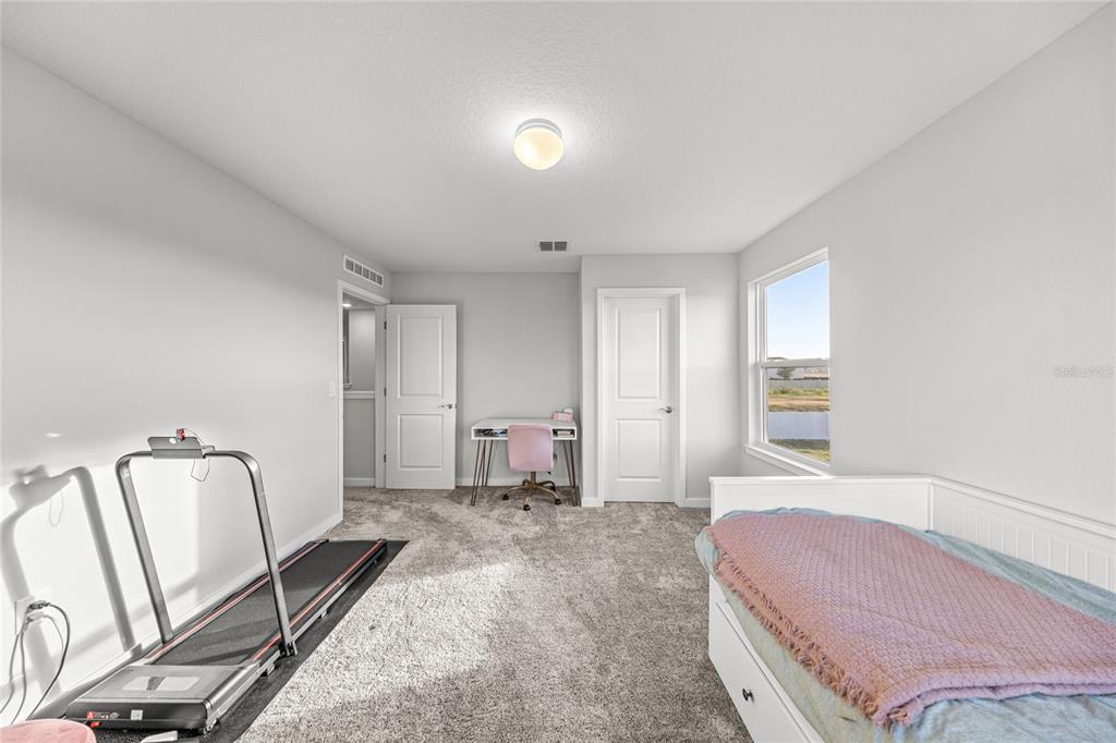 4472 Southwest 84th St Road Ocala, FL 34476 - Photo 41 of 50 a spacious bedroom with a bed and furniture