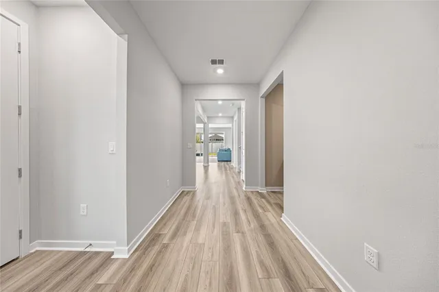 a view of a room with wooden floor