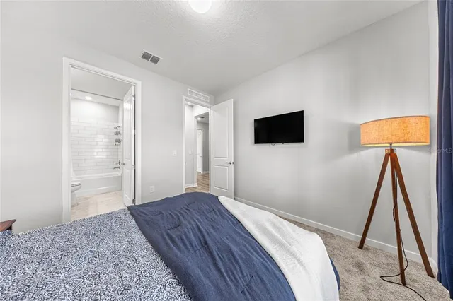 a bedroom with a bed and a flat screen tv